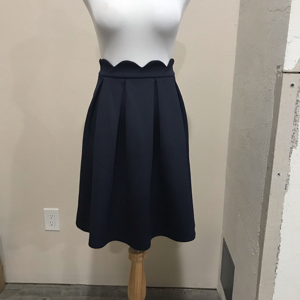 Scalloped waist Alya navy skirt.